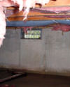 Michigan and Wisconsin crawl space with vents, showing mold, rot, and fiberglass insulation dripping off the ceiling.