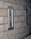 an inside view of foundation wall anchors installed along a basement wall to brace and repair the structure in Washburn