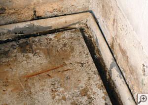 A weeping tile system that incorporates an open gap along the floor that will accept dirt, dust, and debris as well as flooding groundwater.  This installation was completed by a contractor in Centerville.