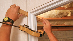 Installing trim and finishing touches to a remodeled basement in Hancock, MI and WI