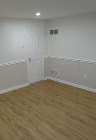 Our complete EverLast™ Finished Wall Restoration System installed in a basement, complete with floor molding and our stylish chair rail.