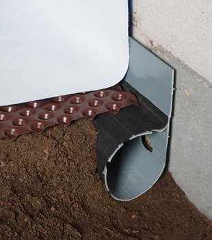 Closeup of a crawl space drainage system installed in Butternut
