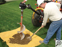 Auguring a hole in the earth for a foundation repair in Woodruff
