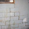 A cracked foundation wall near a window in a Wakefield home