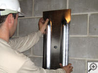 Mounting a foundation wall plate for an earth anchor installation in Minocqua.