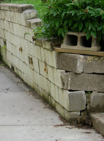 collapsing retaining wall with severe damage in Chassell