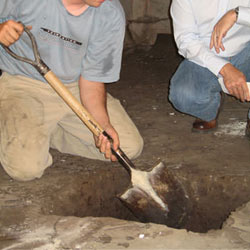 Digging a hole for the engineered fill used in a crawl space support system installation in Eagle River