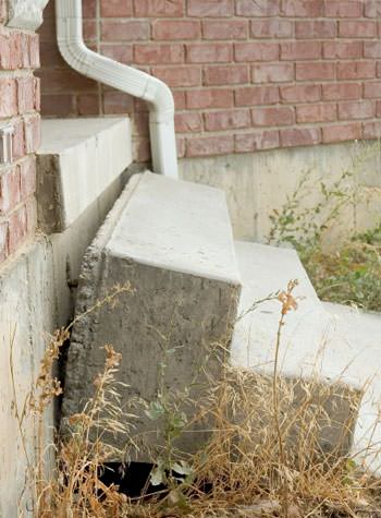 sinking outdoor concrete steps showing cracking and soil washout in Bessemer