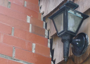 A tilting chimney in Washburn showing serious foundation damage.