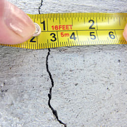 A crack in a poured concrete wall that's showing a normal crack during curing in Saint Germain