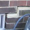 A closeup of a failed tuckpointing job where the brick cracked on a Calumet home.