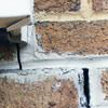 Failed crack repair showing old tuckpointing that cracked on a Marquette home.