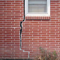A foundation with a large crack that's wider at the top than on the bottom in Butternut