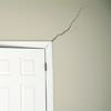 A long drywall crack beginning at the corner of a doorway in a Bessemer home.