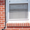 A gap in a window along the outer wall due to foundation settlement of a Crystal Falls home.