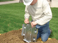 Fastening an earth anchor for a severely bowing wall in Hancock.