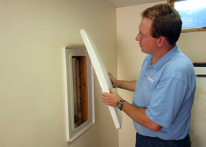 Foundation wall anchor covers installed in a finished basement with a repaired foundation wall in Butternut.