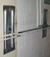 Foundation wall anchor plates installed in a basement in Marquette