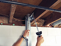Straightening a foundation wall with the PowerBrace™ i-beam system in a Phillips home.