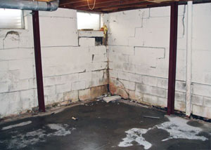 A failed, rusty i-beam foundation wall system installed in Butternut.