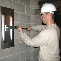 installing a wall anchor to repair an bowing foundation wall in Phillips