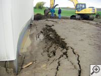 A foundation wall showing severe damage from bowing and buckling in Washburn