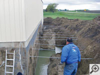 Drilling the hole in the foundation wall for street creep repairs in Lac Du Flambeau