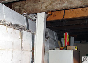 A failing foundation wall and i-beam support in a Ashland home