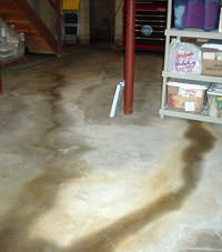 Flooding entering a basement through a floor crack in Bessemer