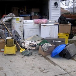 Soaked, wet personal items sitting in a driveway, including a washer and dryer in Eagle River.
